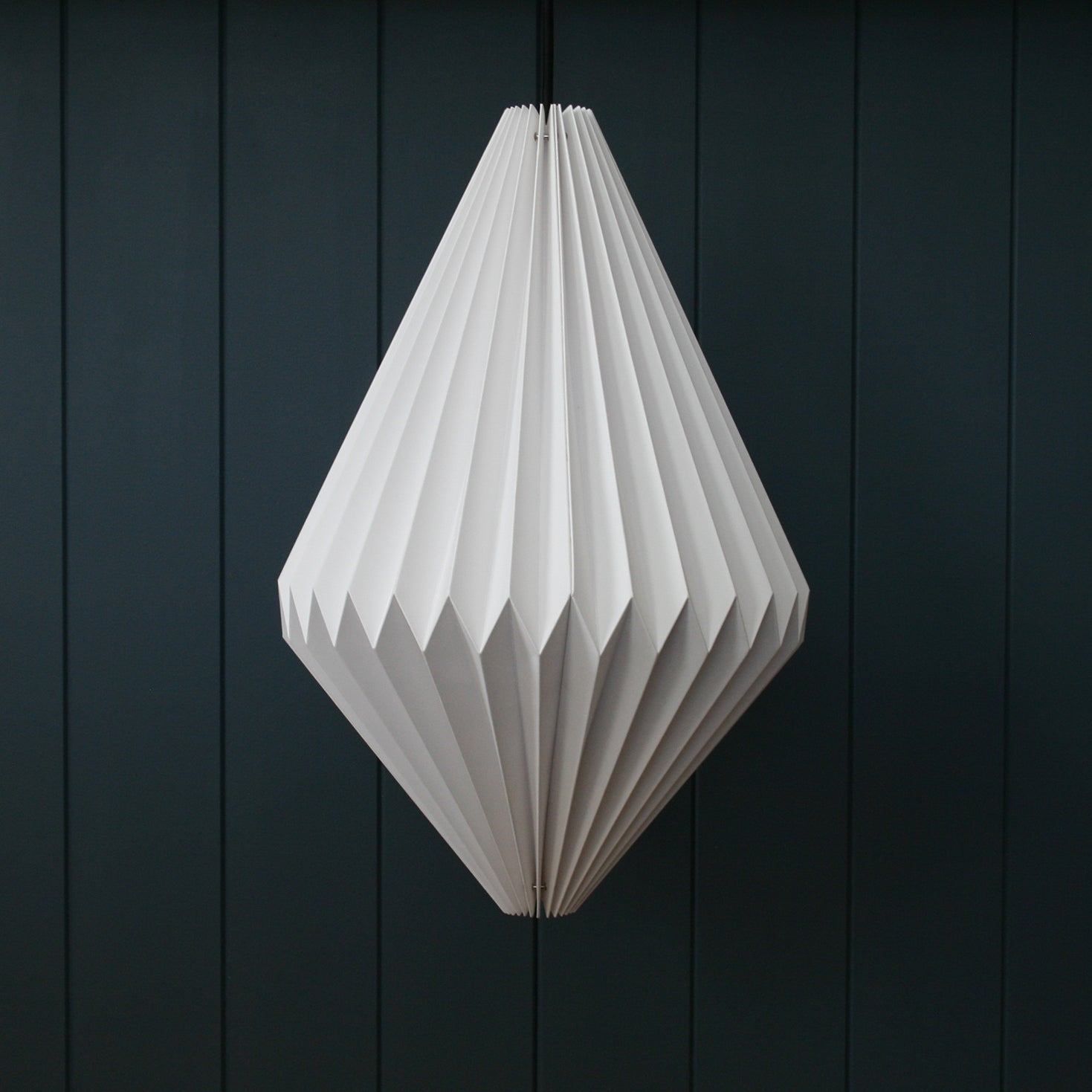 Pear shaped paper light pendant available to buy online - hanging from the ceiling of a kitchen.