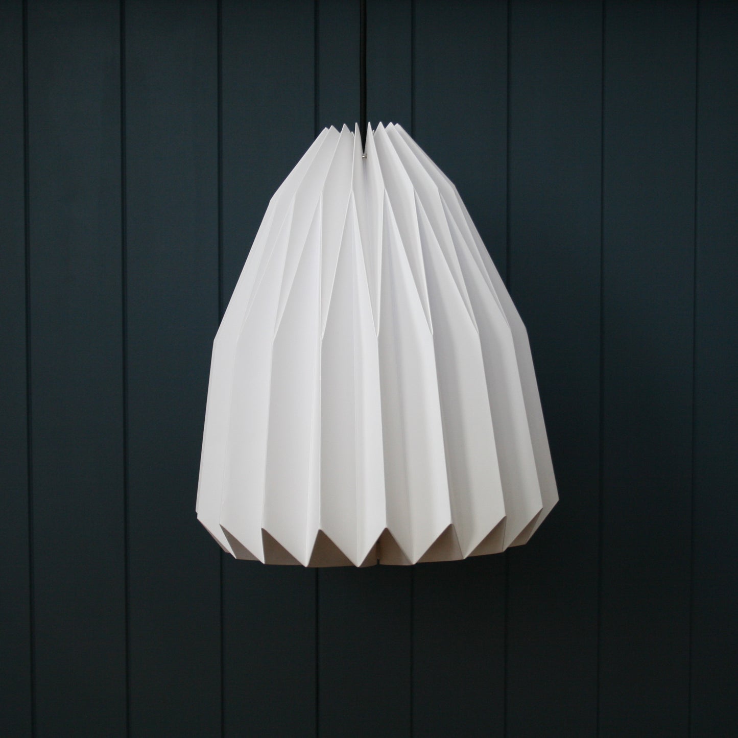 Hanging pepper-shaped paper light pendant in the living room. Inspired by origami / Japanese architecture